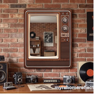 May include: A rectangular wall mirror designed to resemble a vintage television set with a wood-grain frame, a cream-colored screen border, and a control panel on the right side featuring two circular knobs and horizontal speaker grille lines.
