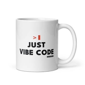 May include: A white ceramic mug featuring the black text JUST VIBE CODE, a red greater-than symbol, and a red vertical rectangle. Below the text, a small black rectangular logo contains the white text deathtodash in a sans-serif font.