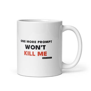 Może przedstawiać: Biały ceramiczny kubek z czarnym napisem "ONE MORE PROMPT" nad pogrubionym czarnym napisem "WON'T" i czerwonym napisem "KILL ME". Pod tekstem znajduje się małe czarne prostokątne logo z białym napisem "deathtoendash".