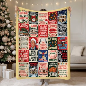 May include: A rectangular throw blanket featuring a grid of colorful squares with Christmas Vacation movie quotes and illustrations, including a station wagon, a moose, a skeleton, a turkey, and the text Allelujah Holy Shit Where's The Tylenol.