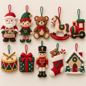 May include: A set of ten felt Christmas ornaments featuring a Santa Claus, an elf, a brown teddy bear, a rocking horse, a train, a drum, a gift box, a nutcracker, a stocking with a bear, and a house, all with green hanging loops.