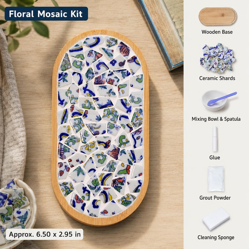 May include: A floral mosaic kit featuring an oval wooden base filled with blue, green, and red patterned ceramic shards. The kit includes a wooden base, ceramic shards, a mixing bowl, a spatula, glue, grout powder, and a cleaning sponge.