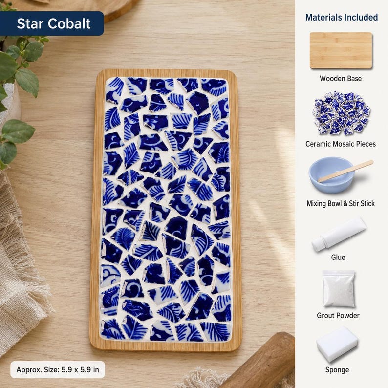 May include: A rectangular wooden tray featuring a mosaic pattern of blue and white ceramic shards. The kit includes a wooden base, ceramic mosaic pieces, a mixing bowl, a stir stick, glue, grout powder, and a sponge. The tray measures 5.9 by 5.9 inches.
