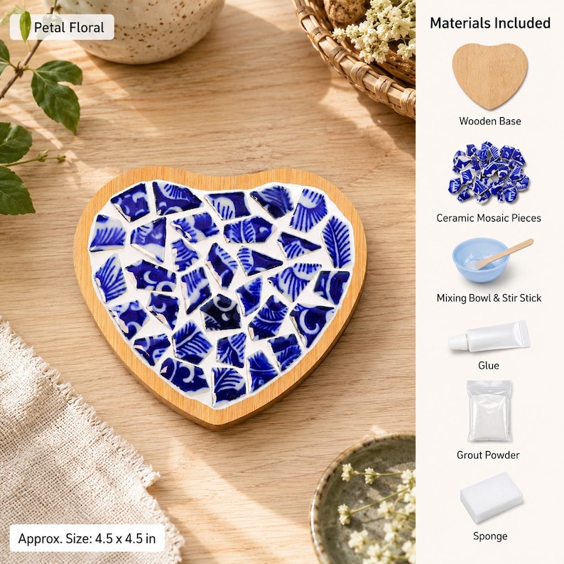 May include: A heart-shaped DIY mosaic kit featuring a wooden base, blue and white ceramic shards, glue, grout powder, a mixing bowl, a stir stick, and a sponge. The finished piece measures approximately 4.5 by 4.5 inches and is labeled Petal Floral.