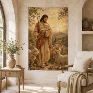 May include: A vertical wall tapestry featuring a painting of a bearded figure in robes holding a small lamb and a wooden staff, surrounded by a flock of sheep in a hilly landscape with a distant cross under a golden sunrise sky.