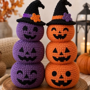 May include: Two stacked crochet pumpkin figures, one purple and one orange, each wearing a black witch hat. The purple pumpkin stack features a purple band and orange star on the hat, while the orange stack has an orange band and purple star.