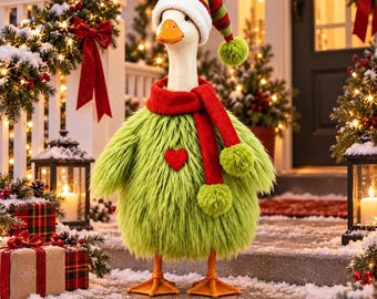 May include: A decorative goose figurine wearing a long, lime green faux fur coat with a red heart patch, a bright red scarf with green pom-poms, and a matching red, green, and white striped Santa hat with a green pom-pom on the end.