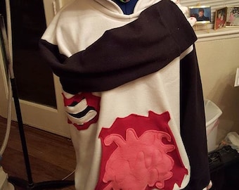 May include: A white and black panda-themed hoodie with a hood featuring black ears and a toothy grin. The hoodie has a red and pink design on the front and black sleeves. The garment is displayed on a mannequin.