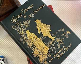 May include: A hardcover book titled "Lorna Doone" by R.D. Blackmore. The cover is dark green with gold lettering and illustrations of two figures. The book includes illustrations by Frank T. Merrill.