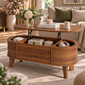 May include: An oval wooden coffee table with a lift-top mechanism, featuring a fluted texture on the exterior sides. The table includes an interior storage compartment containing books, a box, and headphones, with a vase of flowers on top.