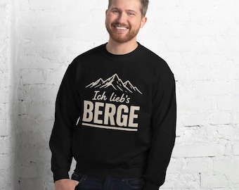 May include: A black long-sleeve sweatshirt featuring a white graphic of mountain peaks above the text Ich lieb's BERGE. The design is centred on the chest, with the word BERGE in large capital letters and a horizontal line below.