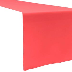 May include: A solid coral-coloured table runner with a smooth, matte texture. The rectangular fabric piece features clean, straight edges and a uniform, vibrant coral hue that extends across the entire visible surface of the textile material.