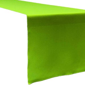 May include: A bright lime green table runner featuring a smooth, solid-colored fabric surface with clean, finished edges. The rectangular textile is draped to show a horizontal section and a vertical drop, displaying a consistent vibrant hue.