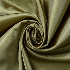 May include: A solid olive green fabric with a smooth, lustrous finish. The material is gathered in the center, creating deep, flowing folds and shadows that highlight the reflective quality of the textile surface and its consistent color tone.