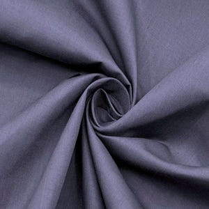 May include: A solid dark purple fabric with a matte finish, featuring a dense weave and a soft texture. The material is gathered in a central spiral, creating deep, flowing folds and shadows that highlight the consistent color and smooth surface.