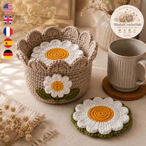 May include: A beige crochet basket with a scalloped rim and a daisy motif on the front. Inside the basket sits a round daisy-shaped coaster. A matching daisy coaster lies flat on the surface. The basket features a white flower with a yellow center.