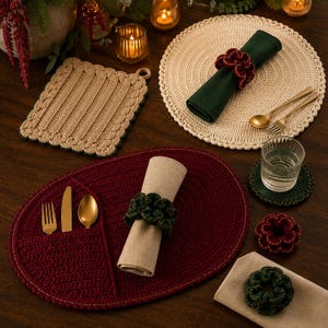 May include: A collection of crochet table linens including a beige square pot holder, a round beige placemat with a dark green napkin and red napkin ring, and an oval burgundy placemat with a built-in utensil pocket, beige napkin, and green ring.