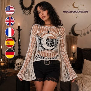 May include: A long-sleeved, off-white crochet top featuring a prominent crescent moon and star pattern on the chest. The garment has a wide, open-knit design with flared sleeves and a round neckline. The text MIQDADCROCHETHUB is visible in the upper right.