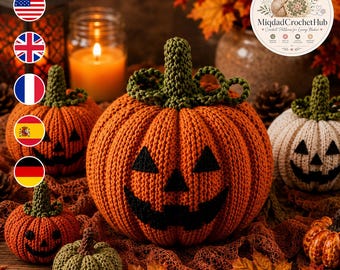 May include: A collection of crocheted pumpkins in orange, white, and green, featuring black stitched jack-o'-lantern faces. The pumpkins have textured ribbed surfaces and green crocheted stems, arranged with autumn leaves and a glowing candle.