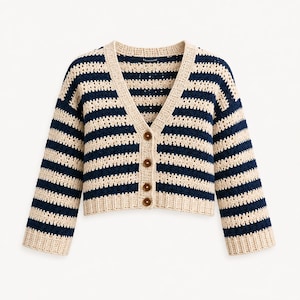 May include: A cropped crochet cardigan featuring horizontal navy blue and cream stripes. The garment has a V-neckline, long sleeves with ribbed cuffs, and a front button closure with four brown circular buttons. The hem is also finished with ribbing.