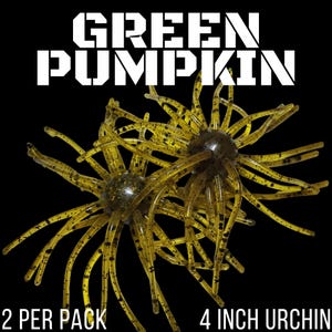May include: Two green pumpkin colored soft plastic fishing lures shaped like sea urchins with multiple thin tentacles and black speckles. The text GREEN PUMPKIN is at the top, and 2 PER PACK 4 INCH URCHIN is at the bottom against a black background.