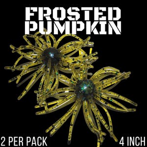 May include: Two translucent olive green fishing lures with black and iridescent glitter flecks, featuring a central round body and multiple radiating tentacles. The text FROSTED PUMPKIN, 2 PER PACK, and 4 INCH is printed in white.
