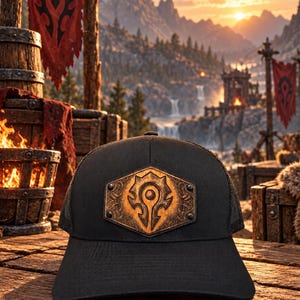 May include: A black baseball cap featuring a hexagonal wooden patch on the front. The patch is engraved with a Horde symbol from World of Warcraft and is secured with four metal rivets. The cap has a structured front panel and a mesh back.