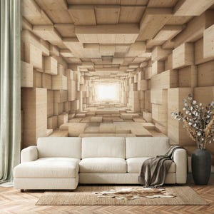 May include: A large wall mural featuring a 3D geometric pattern of light-colored wooden blocks creating a tunnel effect. In front of the wall is a cream-colored sectional sofa with a gray throw blanket, a small rug, and a dark vase with dried flowers.