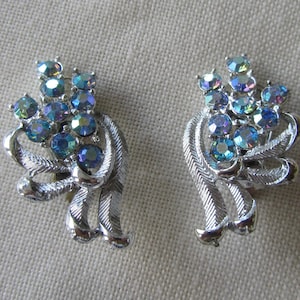 Vintage silver tone clip on earrings with blue rhinestones