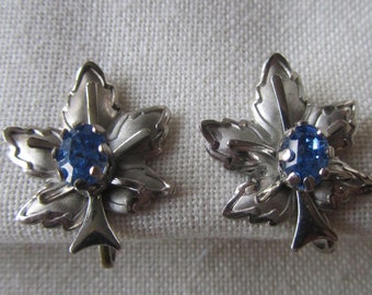 Vintage silver tone screw back leaf earrings with blue rhinestones