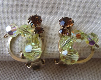 Vintage gold tone Continental clip on earrings with lime and brown rhinestones
