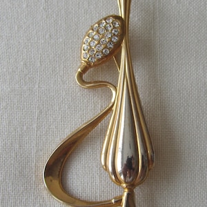 Vintage gold tone snake charmer flute brooch with rhinestones