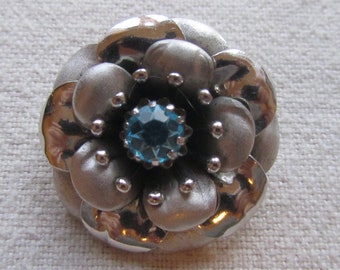 Vintage silver tone small Coro flower brooch with blue rhinestone