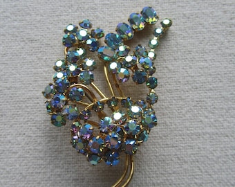 Vintage gold tone unsigned Austria blue rhinestones flower brooch