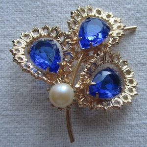 Vintage gold tone blue rhinestones and faux pearl brooch
