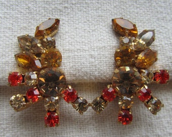 Vintage gold tone Austria clip on earrings with orange and brown rhinestones