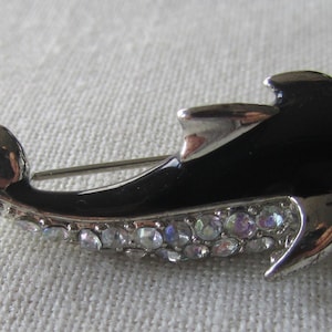 Vintage silver tone black enamel dauphin brooch with rhinestones