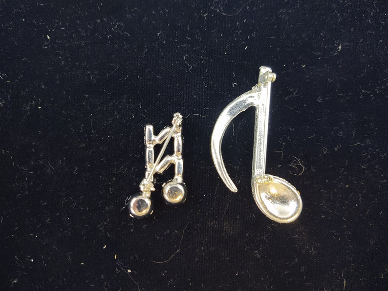 Unsigned Clear Rhinestones Silver Tone Metal Round and Baguette Set of 2 Music Note Brooches