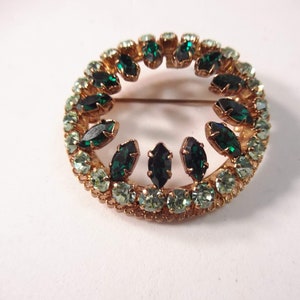 Shades of Green Rhinestone Brooch on Gold Tone Metal, Made in Austria, Bordered with Uranium Rhinestones, Mint Condition, 1 7/8” in Diam