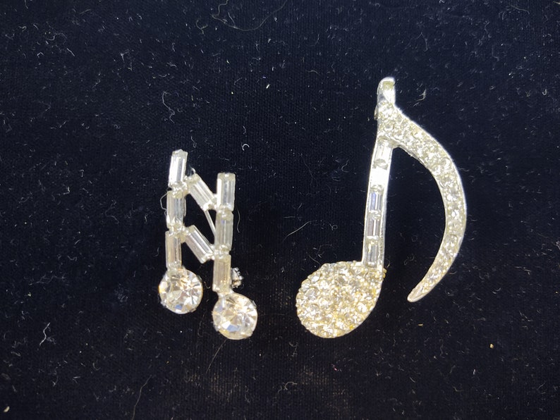 Unsigned Clear Rhinestones Silver Tone Metal Round and Baguette Set of 2 Music Note Brooches