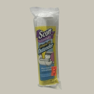 May include: A Scott Extra Soft Simple-Fit Extender for toilet paper rolls, packaged in a clear plastic sleeve. The yellow label features the brand name, product name, and a graphic showing the extender inside a roll, with a red price sticker.