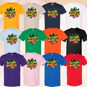 May include: A collection of twelve short-sleeve t-shirts in various solid colors including yellow, beige, navy, white, light blue, green, orange, black, purple, pink, blue, and red, each featuring the Sour Patch Kids logo printed on the front.