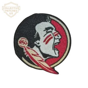May include: A circular embroidered patch featuring a profile of a person with dark hair, red face paint, and an open mouth. The design includes a gold-coloured feather with the letters FSU in red, set against a black and red background.