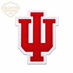 May include: An embroidered patch featuring the Indiana University trident logo in bright red thread with a thick white border. The design consists of a central vertical bar flanked by two curved arms, all outlined in white stitching on a white base.