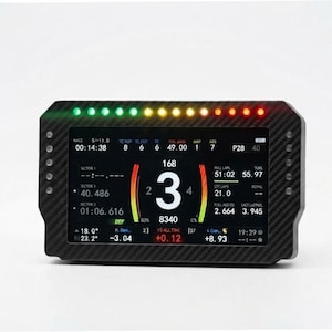 May include: A rectangular digital racing dashboard display with a carbon fiber textured frame. The screen shows telemetry data including speed, gear number 3, RPM, lap times, and sector data. A row of LED lights in green, yellow, and red sits on top.