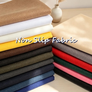 May include: A stack of folded non-slip fabric in various colors including tan, white, cream, yellow, brown, olive, gray, black, blue, red, green, and pink. The material features a textured, perforated surface pattern throughout the entire collection.