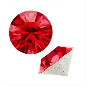 May include: Two red crystal rhinestones, one round and one square, with a faceted design.