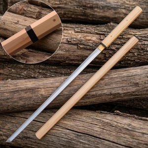 May include: A straight sword with a long, thin, silver-coloured metal blade and a light-coloured wooden handle. The sword includes a matching wooden scabbard. A circular inset shows a close-up of the handle with a dark band and a small hole.