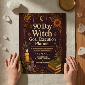 May include: A rectangular planner with a dark purple cover featuring gold text that reads 90 Day Witch Goal Execution Planner. The cover design includes illustrations of a lit candle, crystals, a stack of three books, and botanical elements.