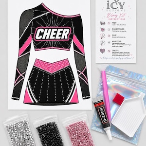 May include: A DIY rhinestone kit featuring a printed design of a black and pink one-shoulder cheer uniform with the word CHEER, an instruction card, a pink wax pen, a white tray, a tube of B-7000 glue, and three bags of silver, black, and pink rhinestones.